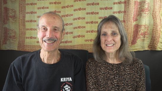 A picture of Lisa and Kenny doing the podcast titled Living in Divine Wonderment.